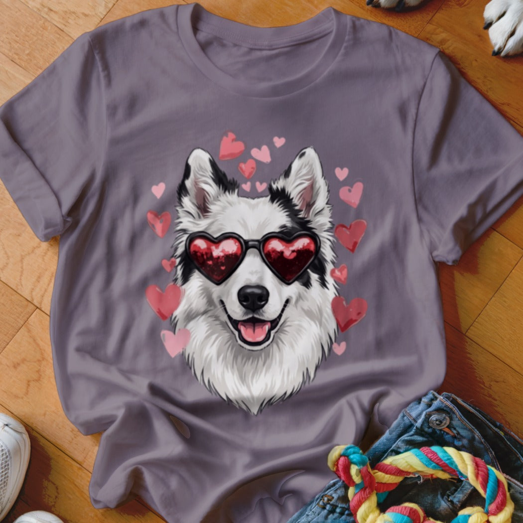 A purple t-shirt featuring a graphic of a white and black dog wearing heart-shaped sunglasses surrounded by pink hearts.