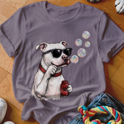 A purple t-shirt featuring a graphic of a white dog wearing sunglasses and blowing bubbles.