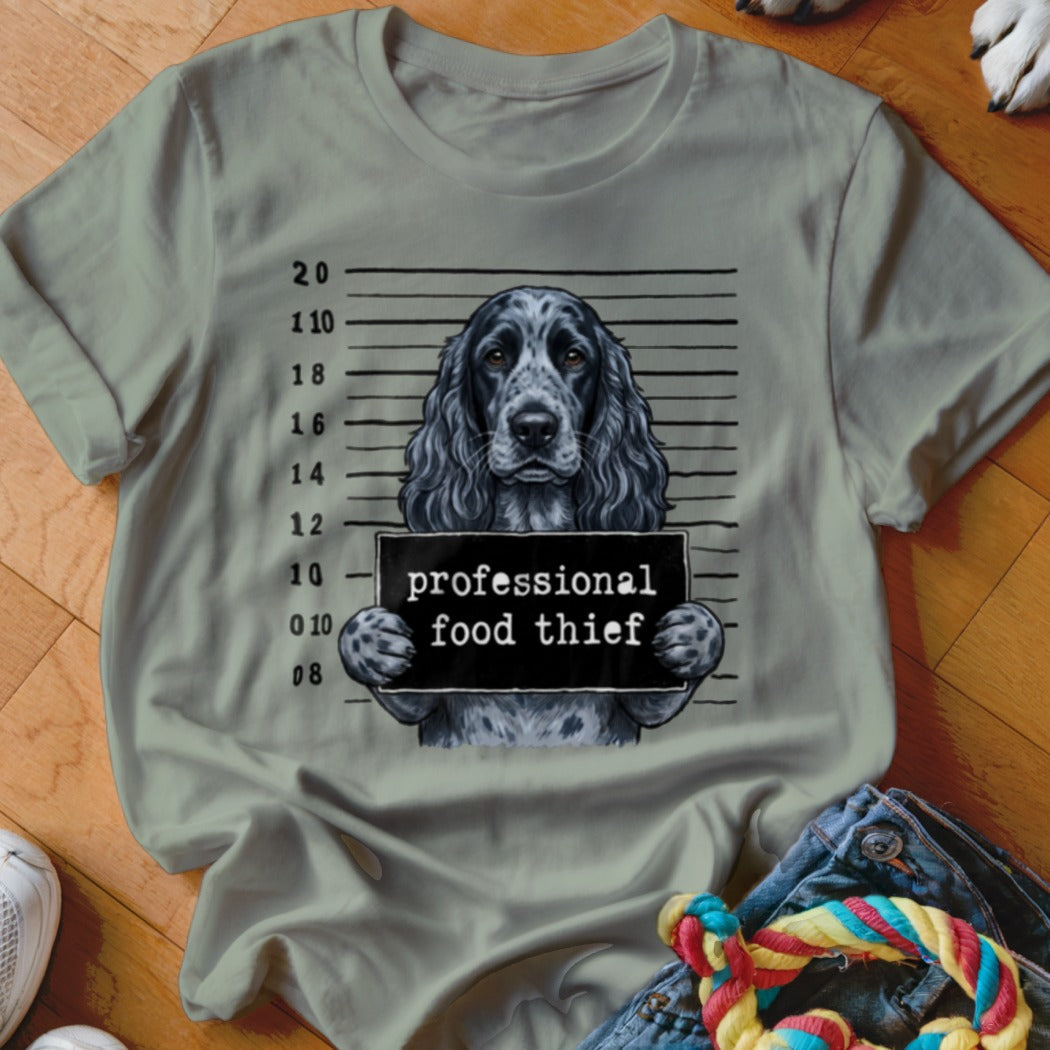 English Springer Spaniel mugshot with "professional food thief" sign.