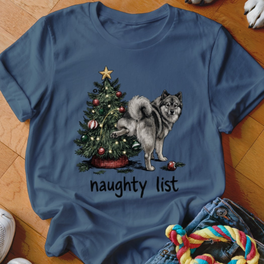 Dog lifting leg on Christmas tree with "naughty list" text.