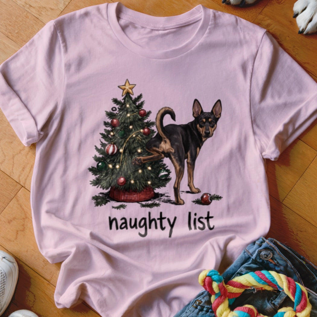 Pink t-shirt with dog next to Christmas tree and text "naughty list".