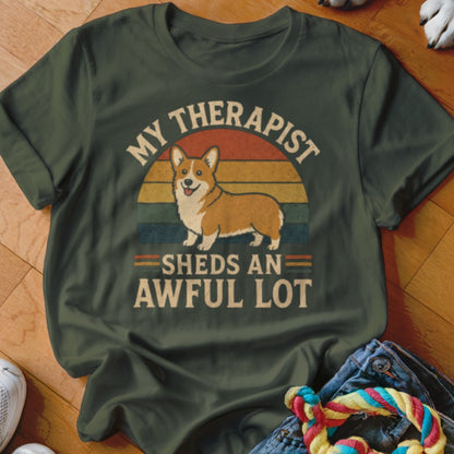 Green t-shirt with a corgi graphic and text "MY THERAPIST SHEDS AN AWFUL LOT."