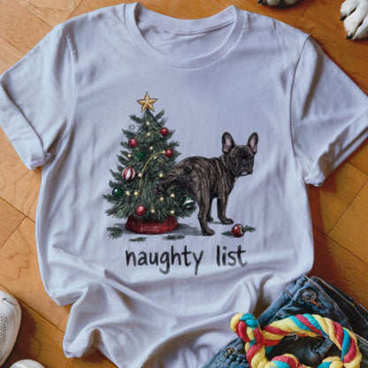 White t-shirt featuring a graphic of a French bulldog peeing on a Christmas tree with the text "naughty list".