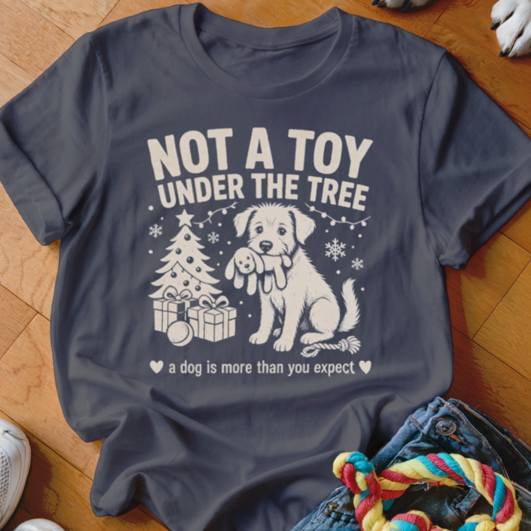 Dark blue t-shirt with white graphic of dog, Christmas tree, gifts. Text reads "NOT A TOY UNDER THE TREE".