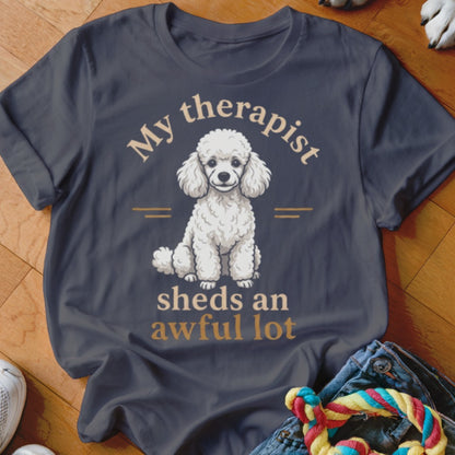 Dark t-shirt with a white poodle graphic and text "My therapist sheds an awful lot".