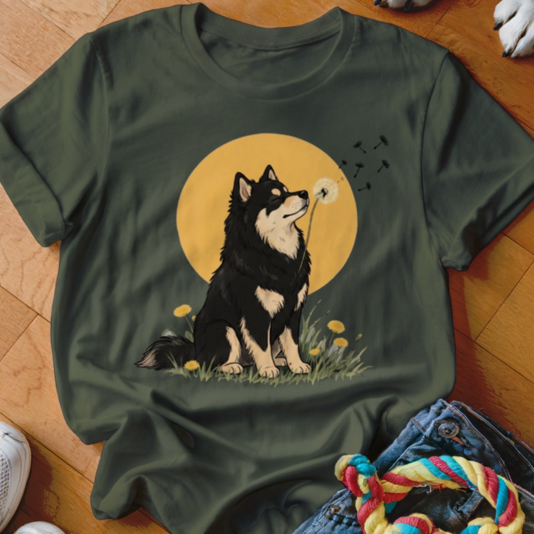 Dark green t-shirt featuring an illustrated black and tan dog blowing a dandelion against a yellow circle.