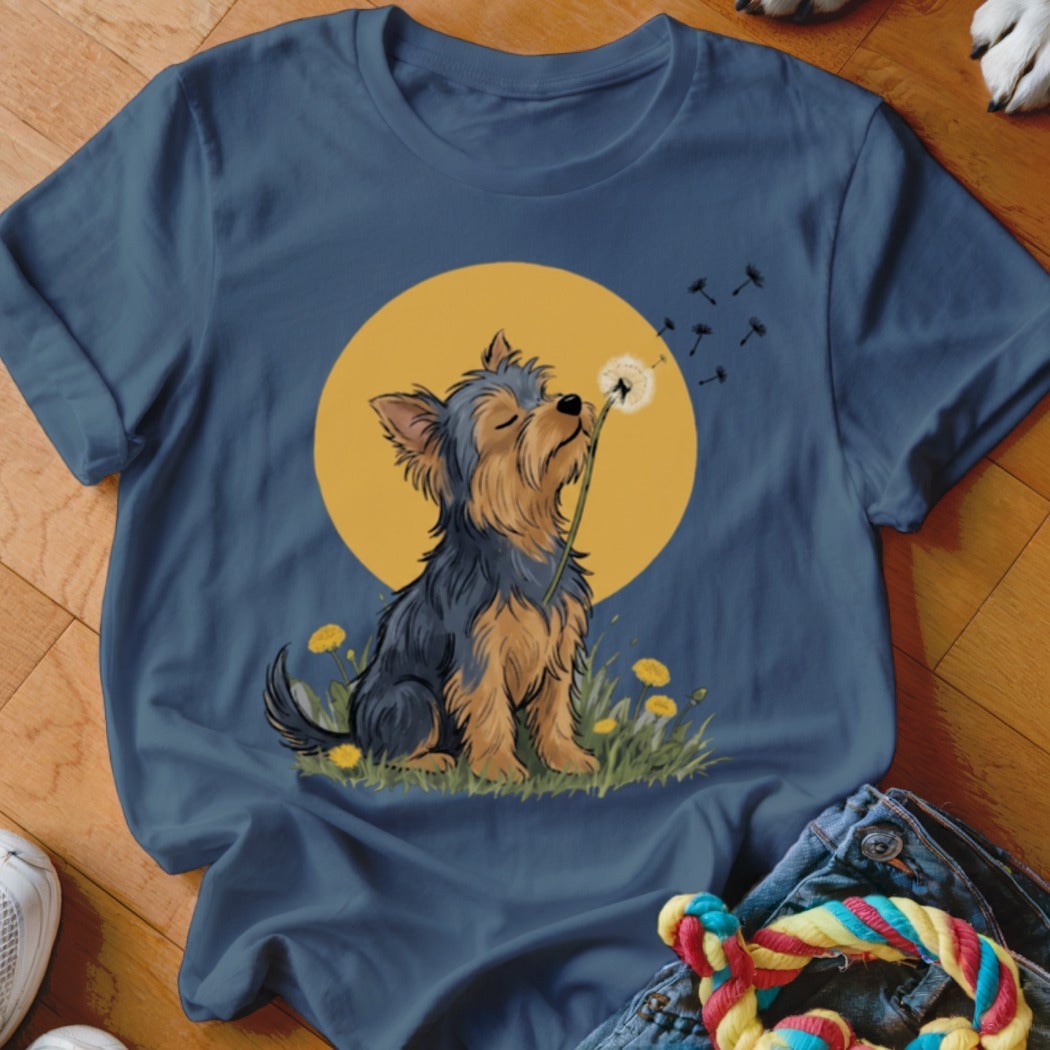 Navy blue t-shirt featuring a cartoon Yorkshire terrier blowing dandelion seeds against a yellow sun.