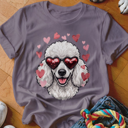 A purple t-shirt features a graphic of a white poodle wearing heart-shaped sunglasses, surrounded by pink hearts.