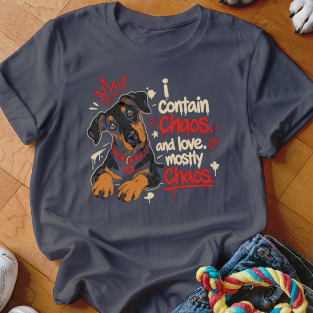 Doberman puppy wearing a crown and collar with text "I contain Chaos and love. Mostly Chaos."