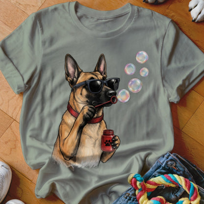 Sage green t-shirt featuring a graphic of a Belgian Malinois wearing sunglasses and blowing soap bubbles.