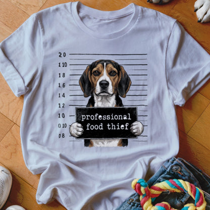 Beagle dog mugshot with "professional food thief" sign.