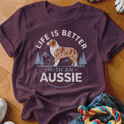 Maroon t-shirt featuring a graphic of an Australian Shepherd, mountains, and the text Life Is Better With An Aussie.