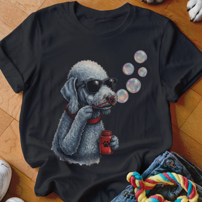 A black short-sleeved t-shirt featuring a graphic of a grey poodle wearing sunglasses and blowing bubbles.