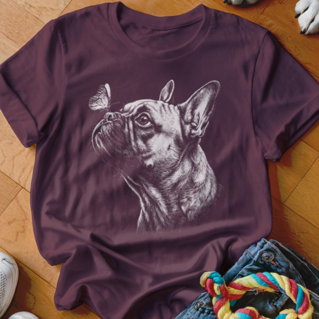 A dark maroon t-shirt with a white sketch of a French bulldog and butterfly.