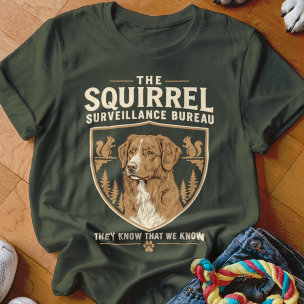 Olive green t-shirt featuring a graphic emblem of a dog, squirrels, and humorous text.