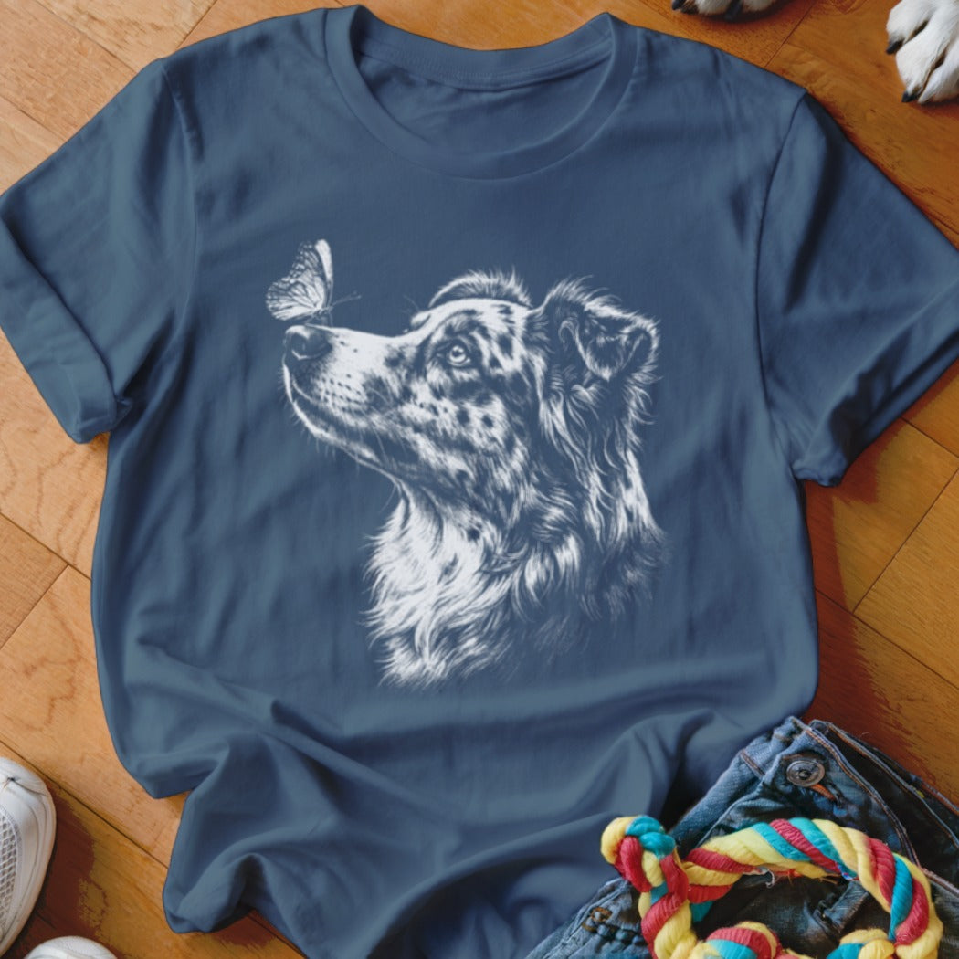 A dark blue crewneck t-shirt featuring a white sketch graphic of a dog looking at a butterfly on its nose.