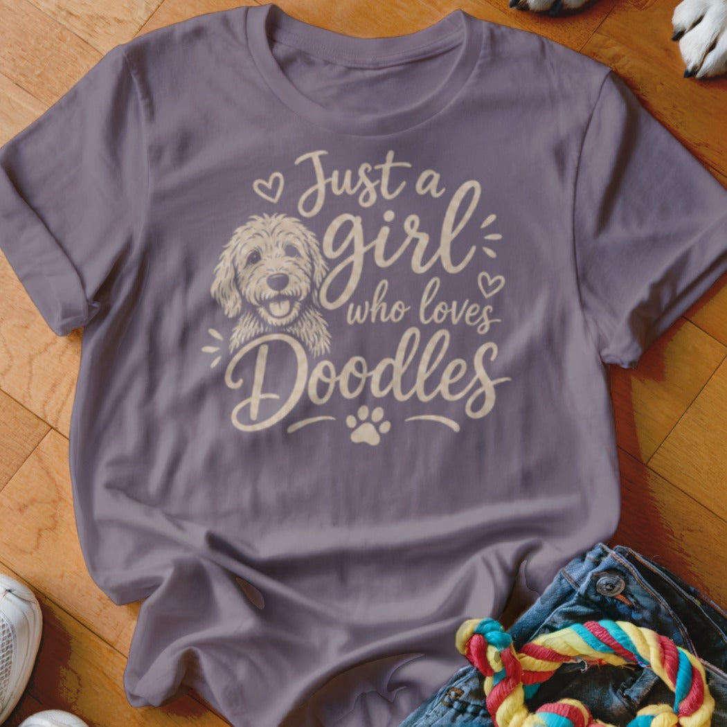 Purple t-shirt with cream text and a doodle dog graphic reading "Just a girl who loves Doodles".