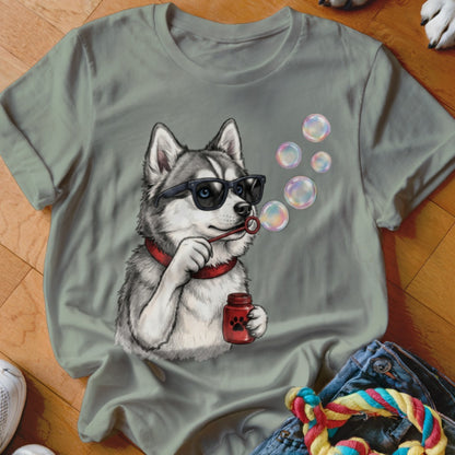 Sage green t-shirt featuring a graphic of a husky wearing sunglasses and blowing soap bubbles.