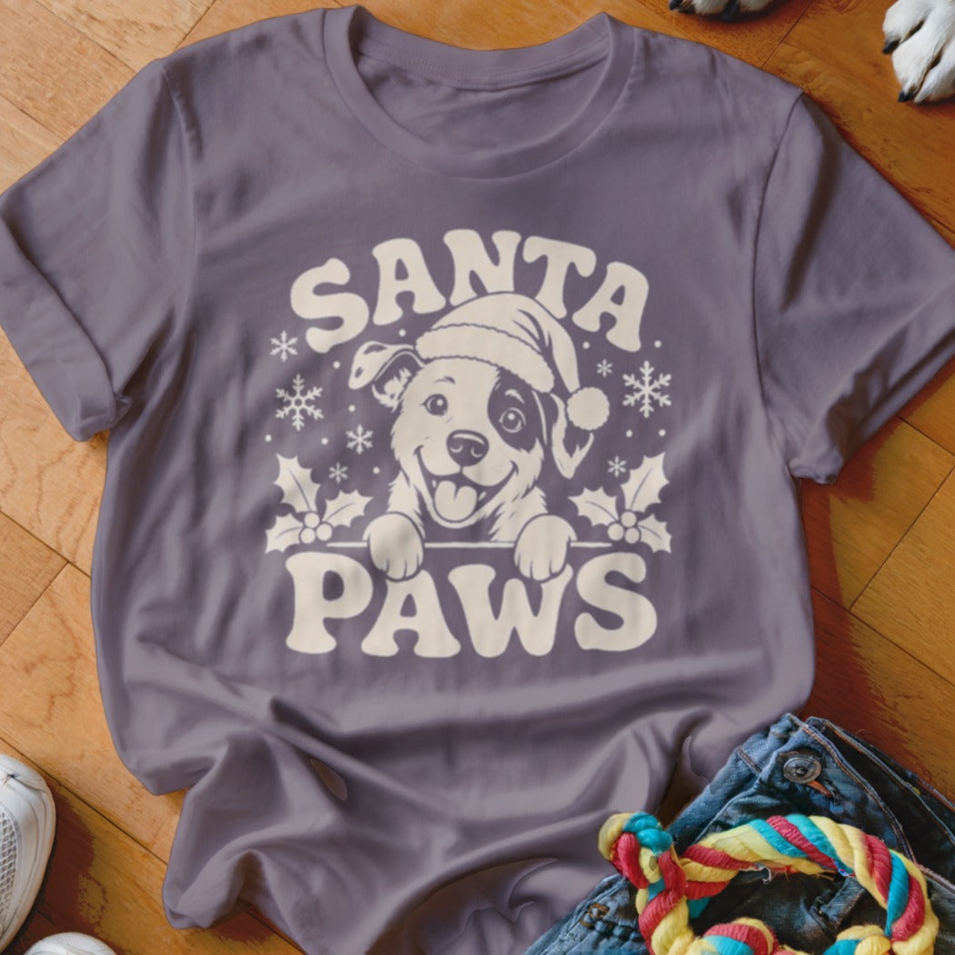 T-shirt with cream graphic of smiling dog in Santa hat and text "SANTA PAWS."