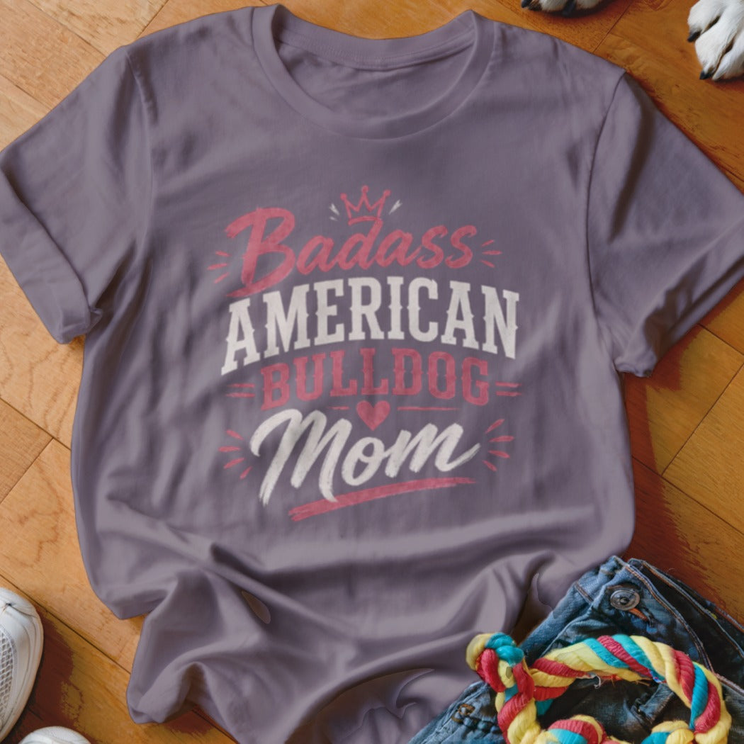 Purple t-shirt with "Badass American Bulldog Mom" text and crown graphic.