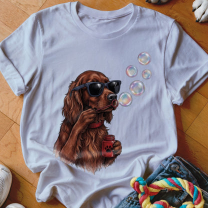 A white t-shirt featuring an illustration of a brown dog wearing sunglasses and blowing bubbles.