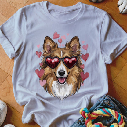 White crewneck t-shirt featuring a graphic of a brown and white dog wearing heart-shaped sunglasses, surrounded by pink hearts.