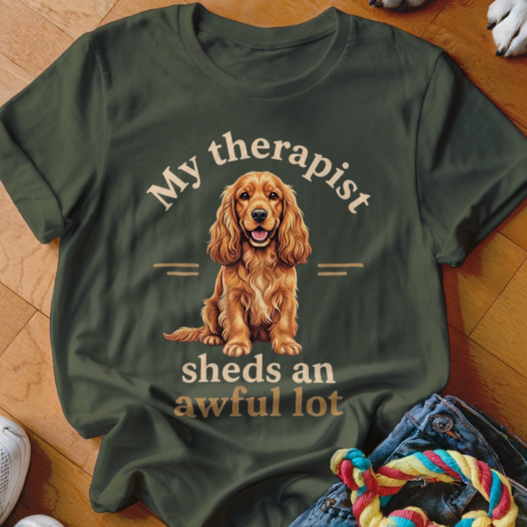 Dark green t-shirt with a dog graphic and text "My therapist sheds an awful lot".