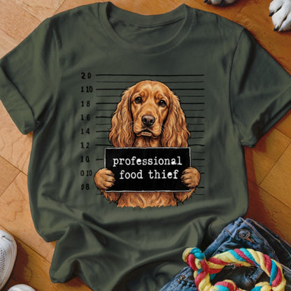 Dog with a "professional food thief" sign in mugshot background.
