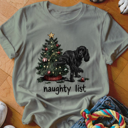 Black dog near Christmas tree with text "naughty list".