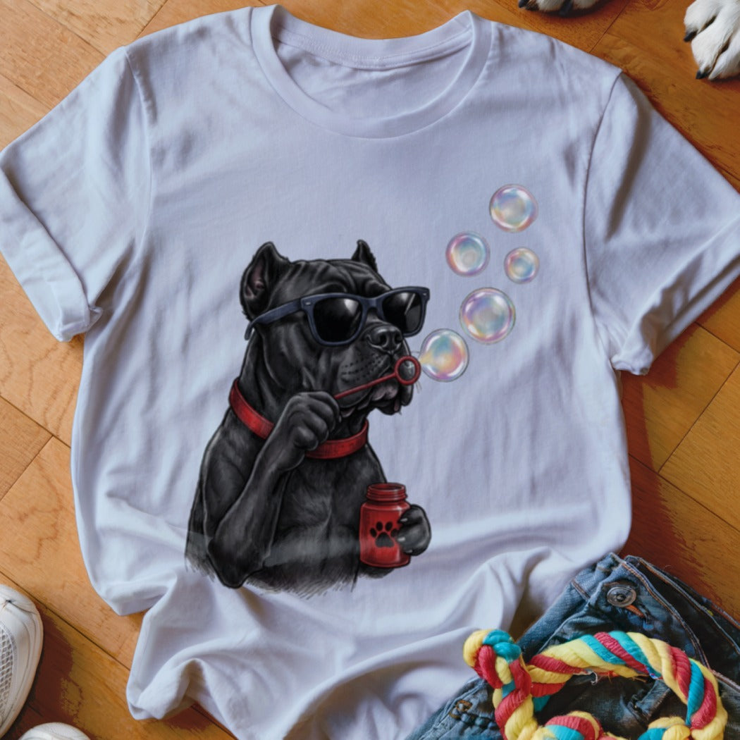 A white t-shirt featuring a graphic of a black dog wearing sunglasses and blowing bubbles.