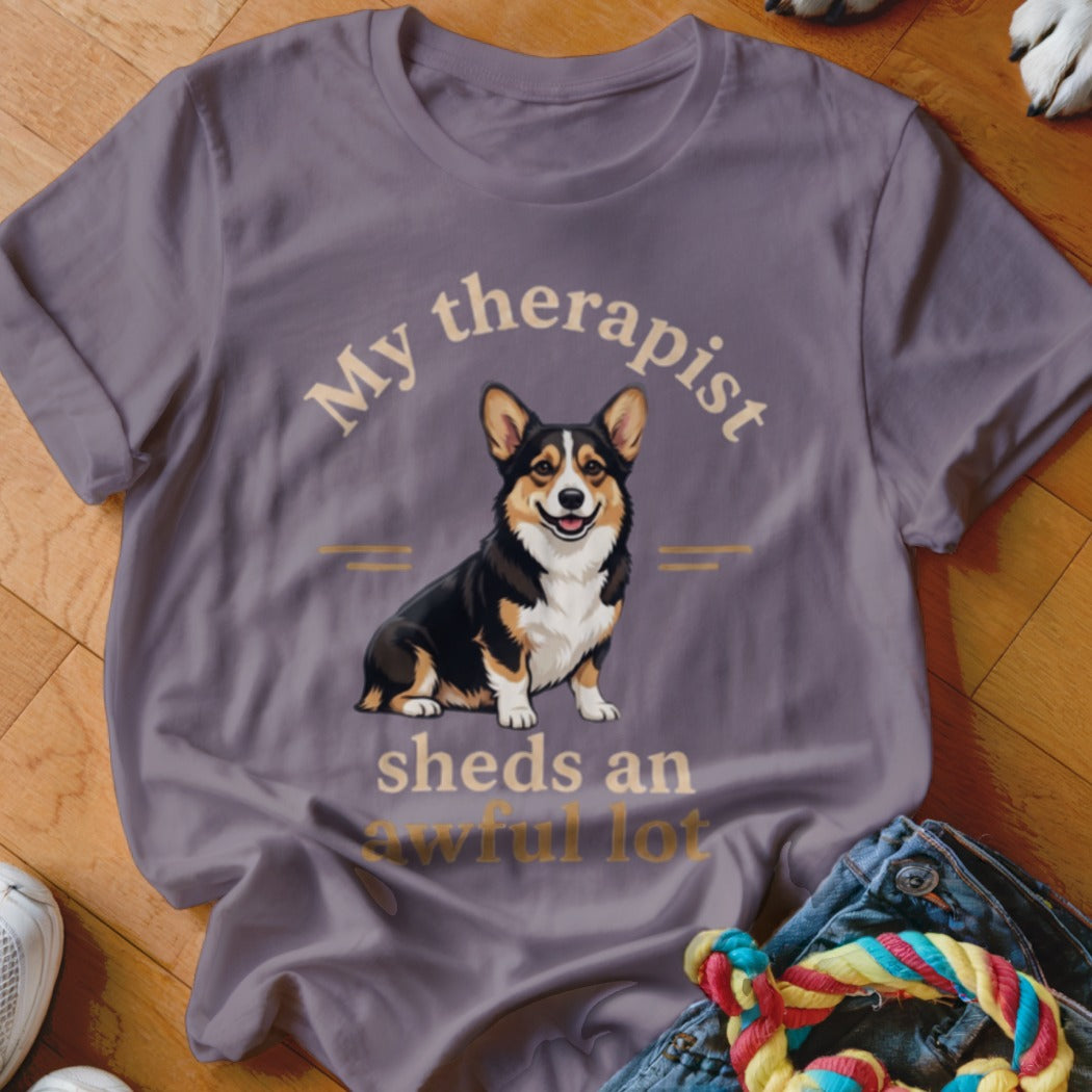 Purple t-shirt with text "My therapist sheds an awful lot" and a corgi dog illustration.