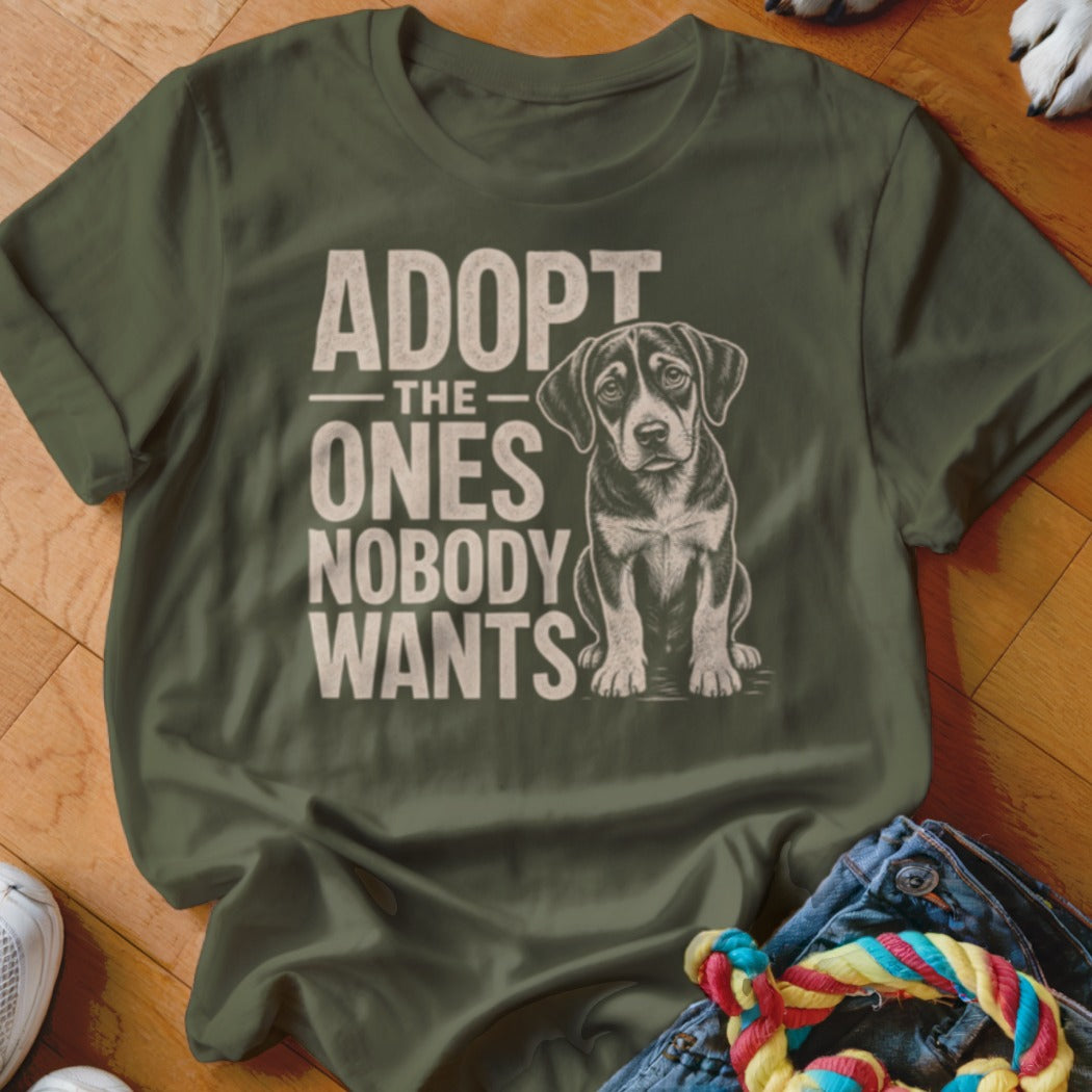 Olive t-shirt with text "ADOPT THE ONES NOBODY WANTS" and a dog illustration.