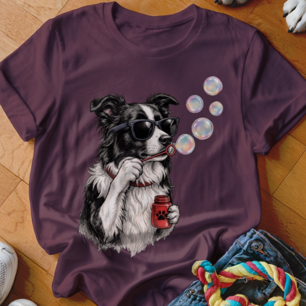 Plum-colored t-shirt featuring a graphic of a black and white dog blowing bubbles.