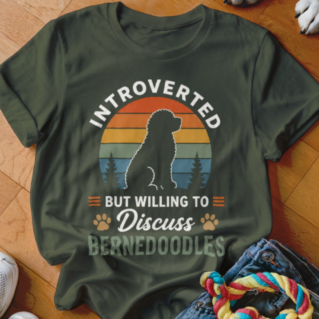 Olive green t-shirt with a silhouette of a Bernedoodle dog and text "Introverted but willing to discuss Bernedoodles."