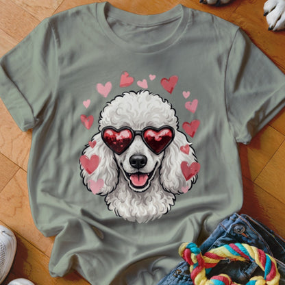 Sage green t-shirt featuring a graphic of a white poodle wearing heart-shaped sunglasses surrounded by pink hearts.
