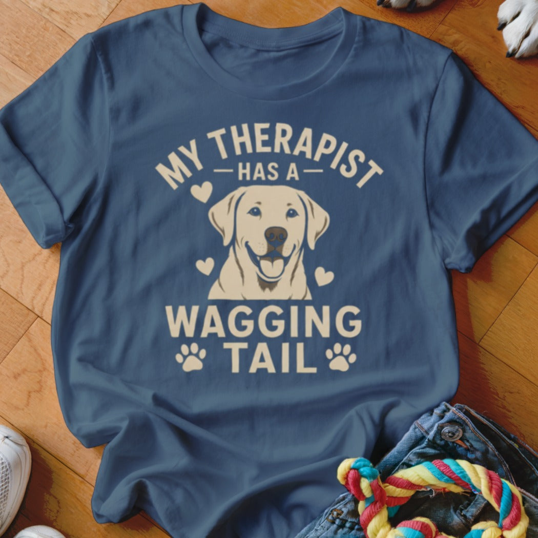 Blue t-shirt with dog graphic and text "My therapist has a wagging tail".