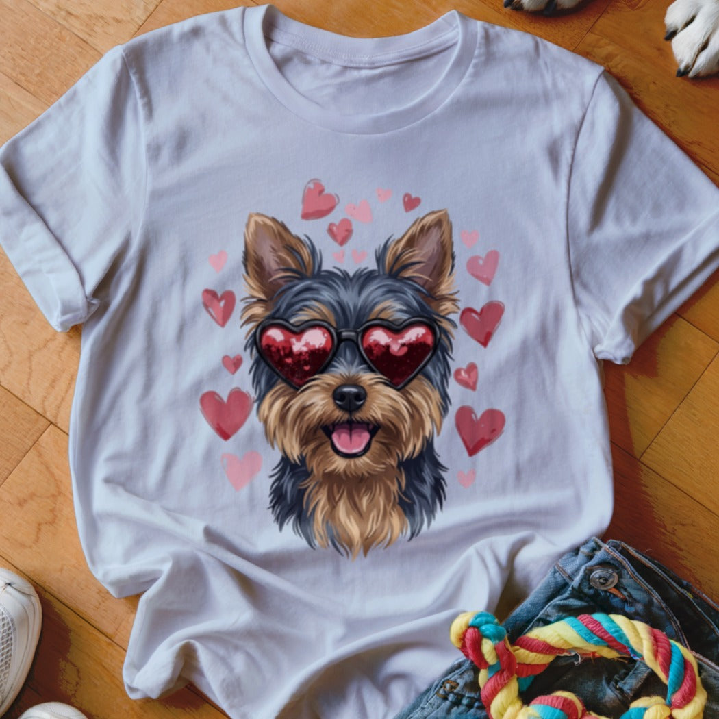 A white crewneck t-shirt features a graphic of a Yorkshire Terrier wearing red heart sunglasses, surrounded by pink hearts.