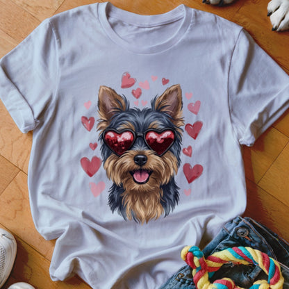 A white crewneck t-shirt features a graphic of a Yorkshire Terrier wearing red heart sunglasses, surrounded by pink hearts.