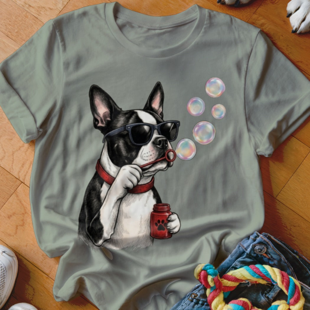 A gray crewneck t-shirt featuring a graphic of a Boston Terrier wearing sunglasses and blowing bubbles.