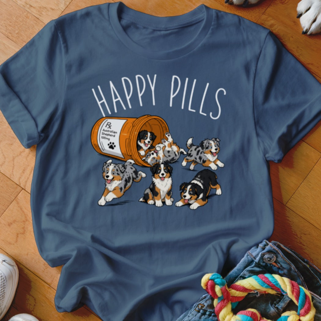 T-shirt graphic with "HAPPY PILLS" text and Australian Shepherd puppies spilling from a pill bottle.