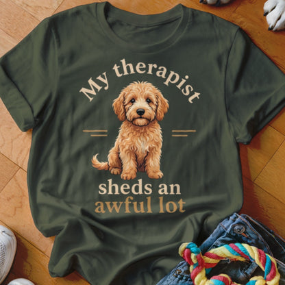 Dark green t-shirt with a fluffy goldendoodle and text "My therapist sheds an awful lot".