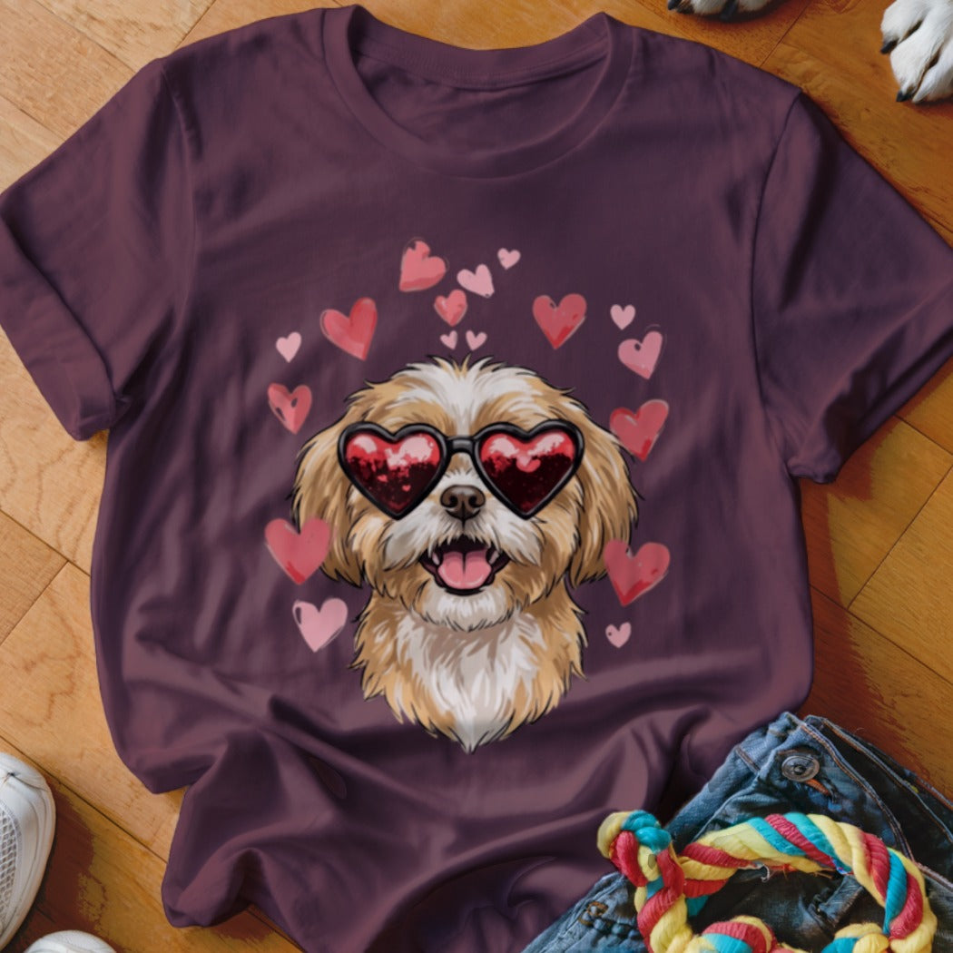 Maroon t-shirt featuring a graphic of a fluffy dog wearing heart-shaped sunglasses surrounded by pink hearts.