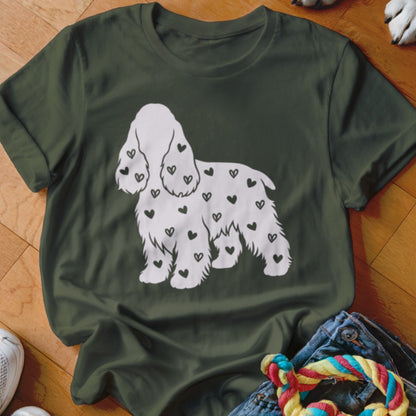 Green t-shirt with a white dog silhouette filled with black hearts.