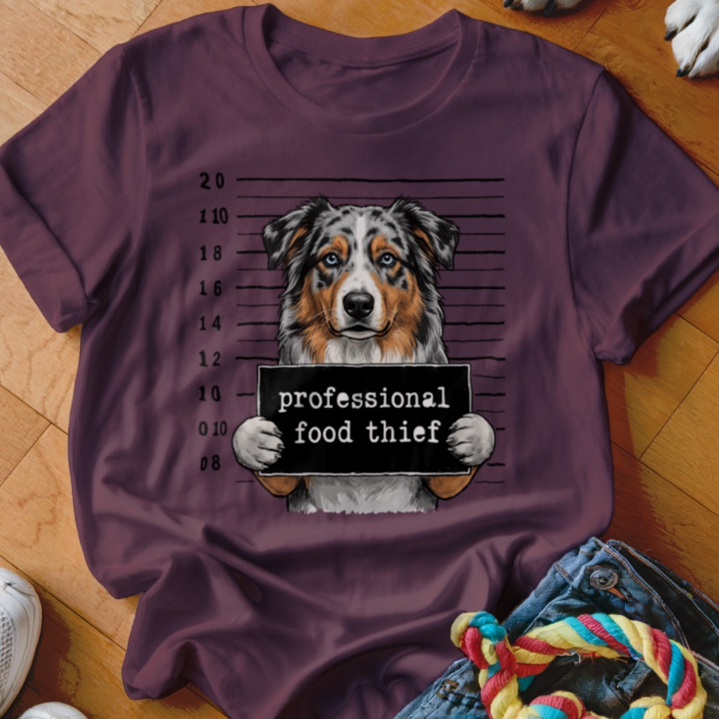 Dog wearing a sign that says "professional food thief" against a police lineup background.