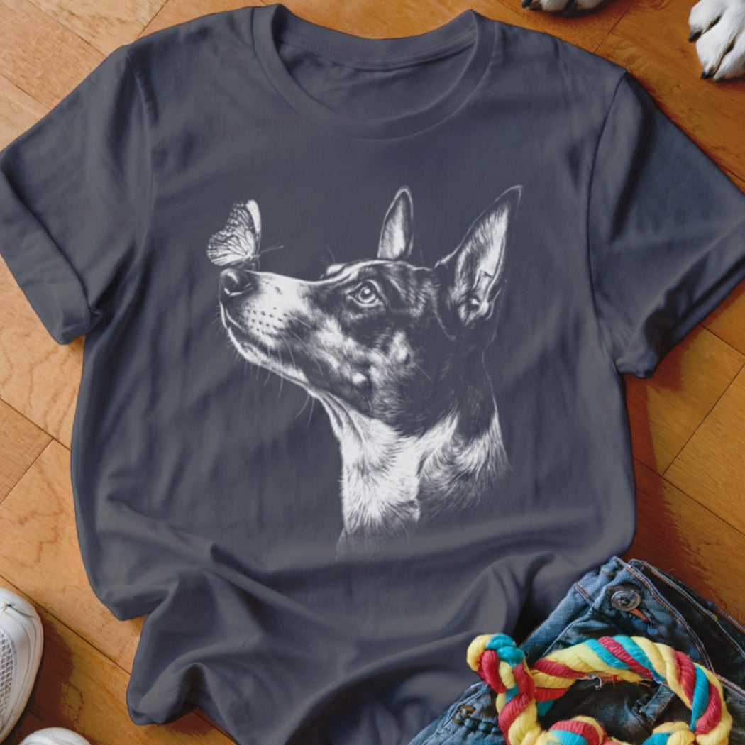 A dark grey t-shirt features a white sketch of a dog looking at a butterfly on its nose.
