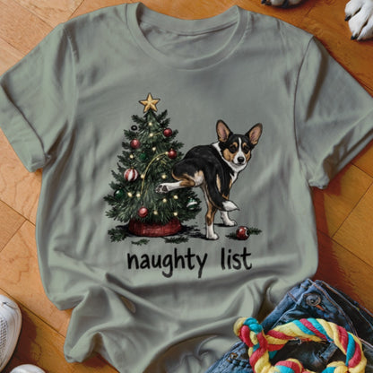 Tricolor corgi by Christmas tree with "naughty list" text.