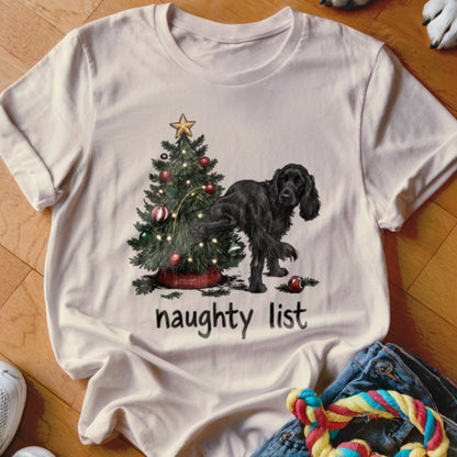 Black dog by Christmas tree with lights, text "naughty list".