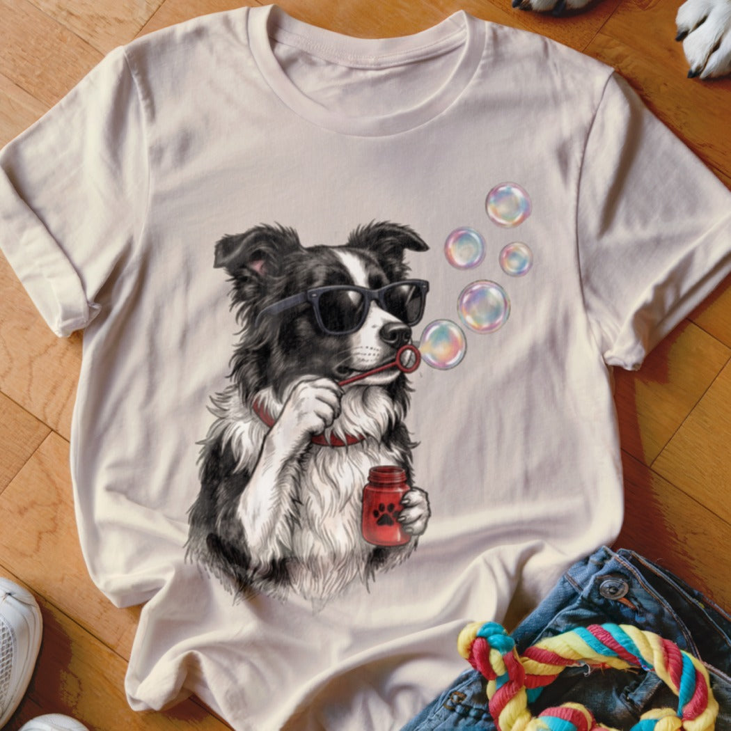 Light beige crewneck t-shirt featuring a graphic of a black and white dog wearing sunglasses and blowing bubbles.