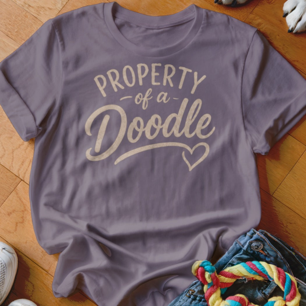 Purple t-shirt with "PROPERTY of a Doodle" text and heart graphic.