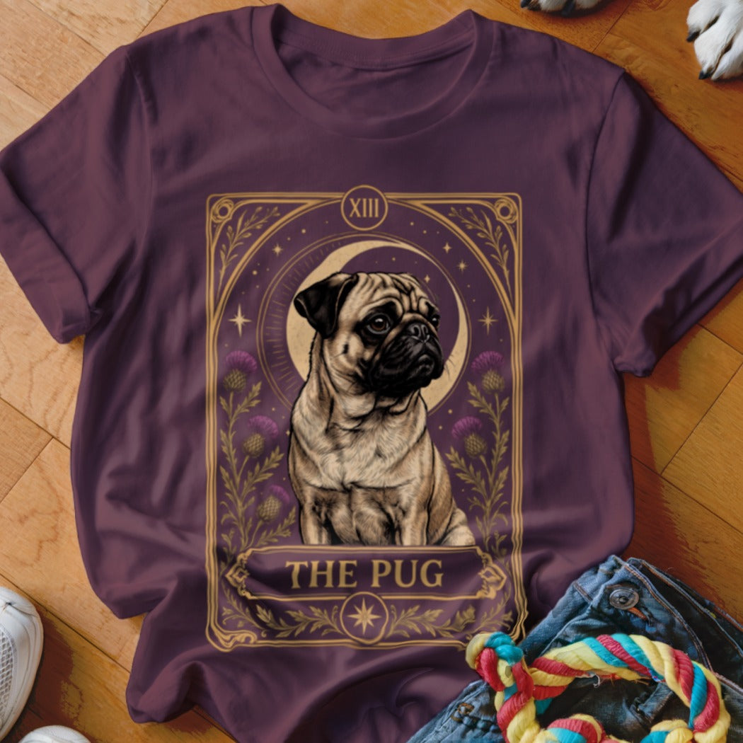 A dark purple t-shirt featuring a tarot card design with a pug and the text "THE PUG."